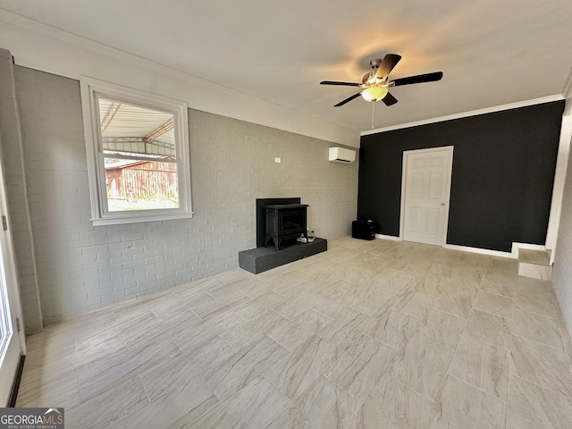 unfurnished living room featuring ornamental molding, an AC wall unit, a wood stove, and a ceiling fan