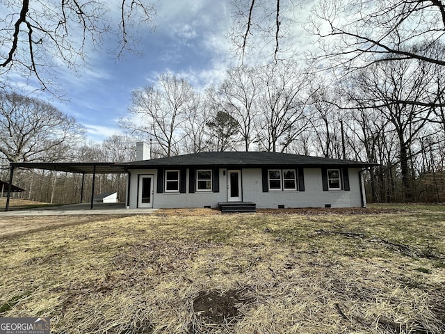 view of front of property featuring an attached carport, crawl space, and a chimney