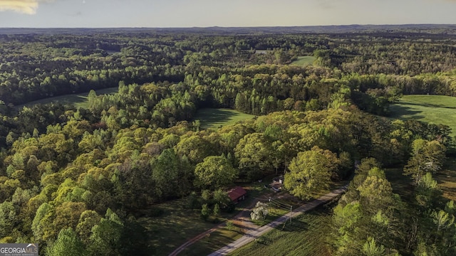 birds eye view of property featuring a view of trees