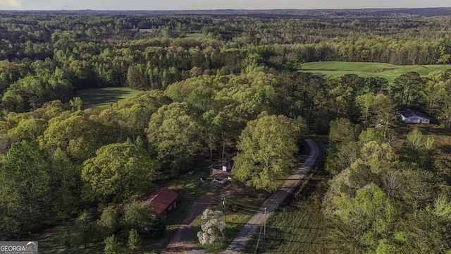 drone / aerial view featuring a view of trees