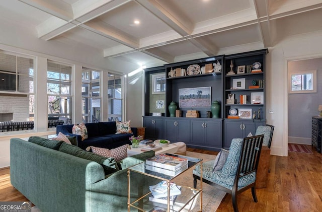 living room with baseboards, beamed ceiling, coffered ceiling, and wood finished floors