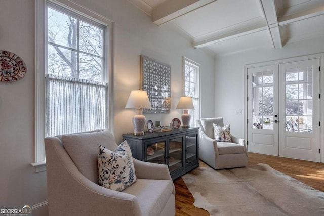 sitting room featuring french doors, wood finished floors, beam ceiling, and coffered ceiling