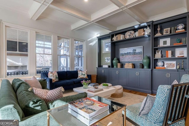 living area with wood finished floors, beam ceiling, and coffered ceiling