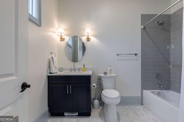 full bathroom with toilet, vanity, baseboards, and shower / washtub combination