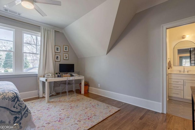 bedroom featuring visible vents, baseboards, wood finished floors, and lofted ceiling