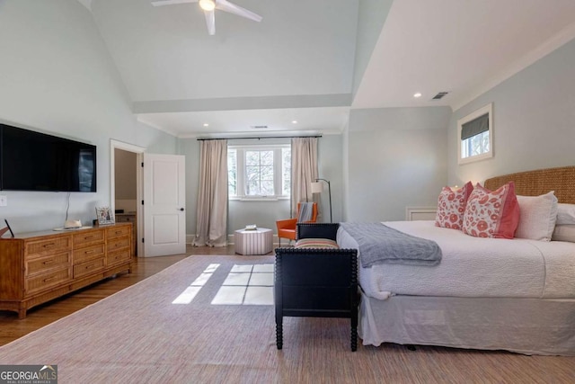 bedroom with wood finished floors, lofted ceiling, multiple windows, and visible vents