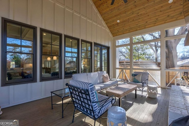 sunroom / solarium featuring high vaulted ceiling, a deck, wood ceiling, and wood finished floors