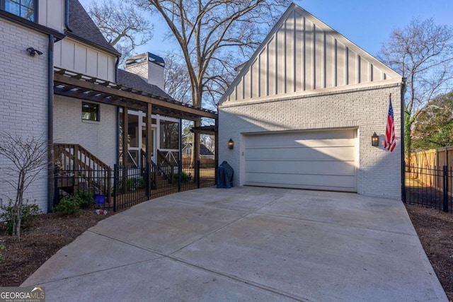 garage with driveway and fence
