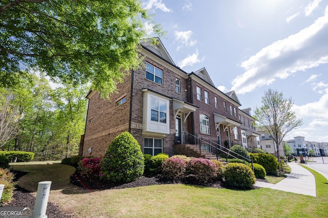 1026 Township Sq, Alpharetta, GA 30022 - view of front of home featuring a residential view, a front lawn, and brick siding