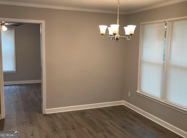 5516 Westberry Ln, Norcross, GA 30071 - unfurnished dining area with dark wood-type flooring, a chandelier, baseboards, crown molding, and a ceiling fan