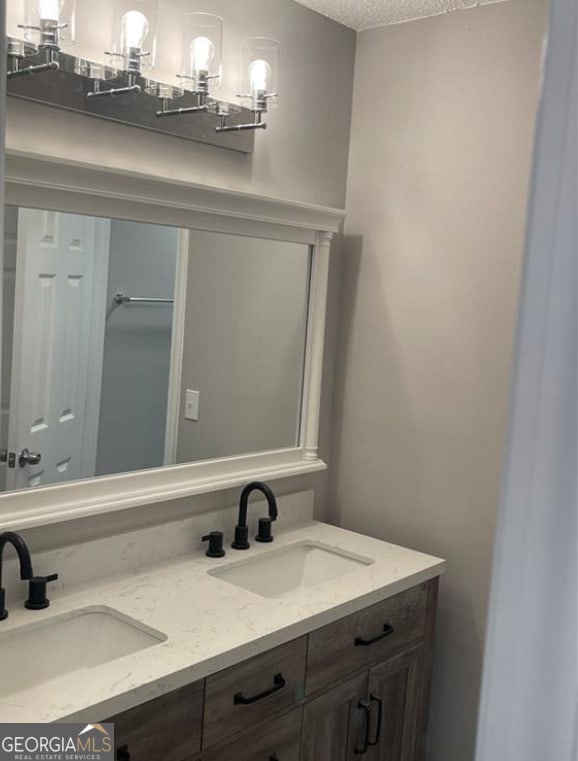 5516 Westberry Ln, Norcross, GA 30071 - bathroom with a textured ceiling and double vanity