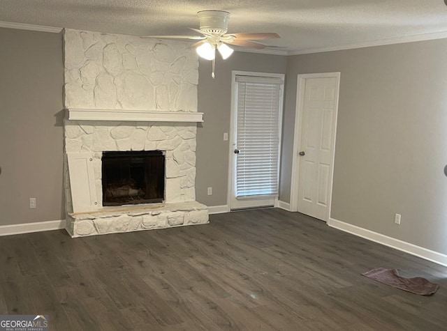 unfurnished living room with baseboards, ornamental molding, ceiling fan, a fireplace, and dark wood finished floors