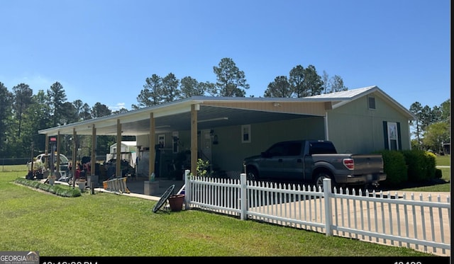 75 Ellis Jones Ln, Baxley, GA 31513 - rear view of property with an attached carport, a yard, and a fenced front yard