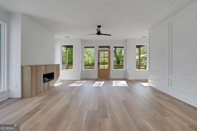 644 Glendale Rd, Scottdale, GA 30079 - unfurnished living room featuring a fireplace, light wood finished floors, baseboards, and ceiling fan