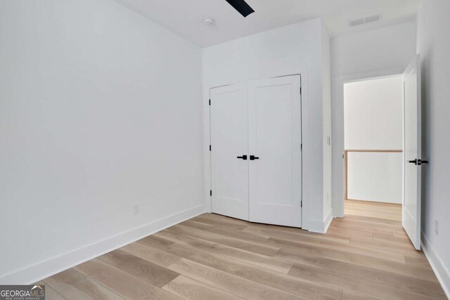 644 Glendale Rd, Scottdale, GA 30079 - unfurnished bedroom featuring ceiling fan, light wood-style flooring, a closet, visible vents, and baseboards