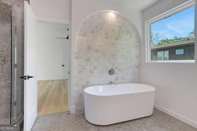 644 Glendale Rd, Scottdale, GA 30079 - bathroom with baseboards and a soaking tub