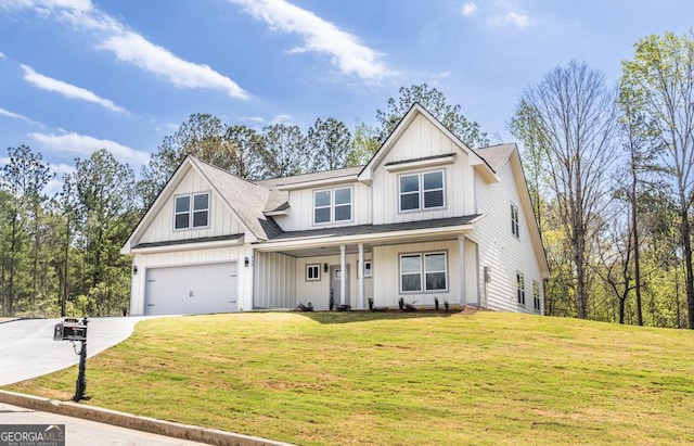 view of front facade with board and batten siding, covered porch, a front lawn, an attached garage, and driveway