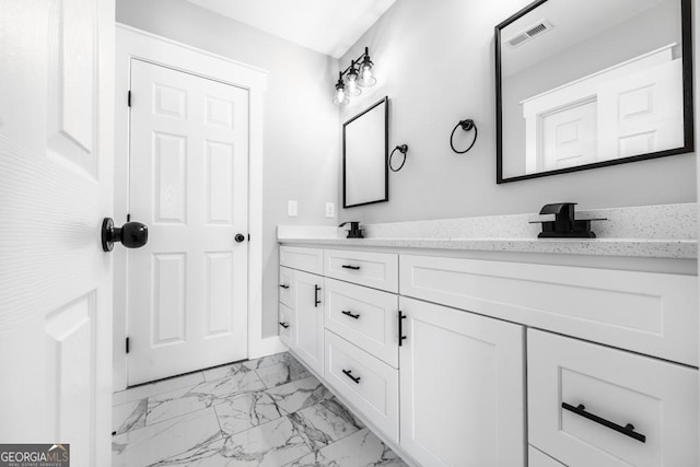 full bath with double vanity, marble finish floor, a sink, and visible vents