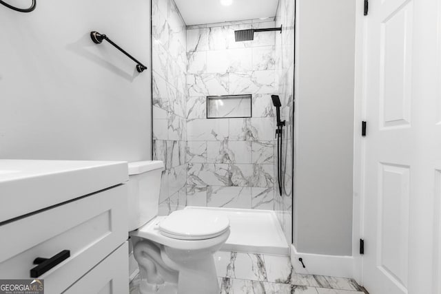 bathroom featuring a shower stall, vanity, marble finish floor, and toilet