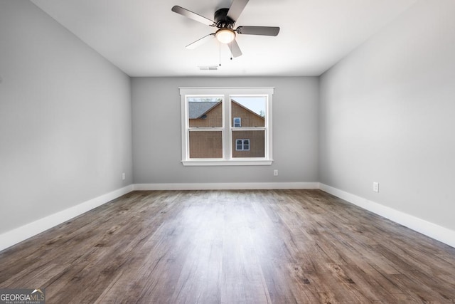 unfurnished room featuring visible vents, baseboards, a ceiling fan, and wood finished floors