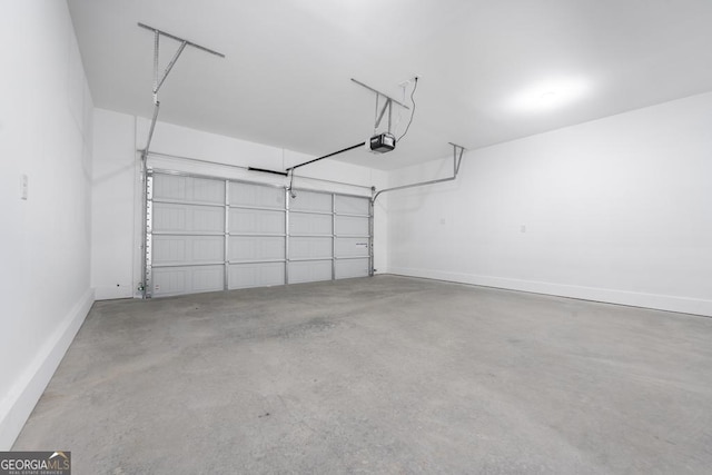 garage with a garage door opener and baseboards