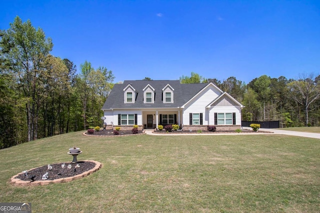 cape cod house featuring a front lawn and fence