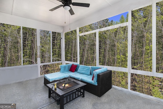 sunroom / solarium featuring ceiling fan and an outdoor fire pit