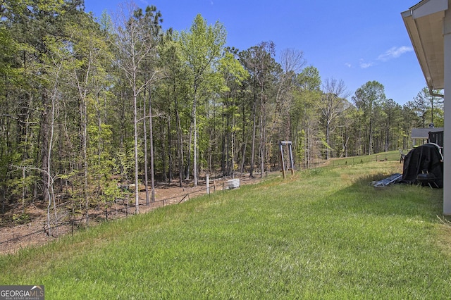 view of yard featuring a wooded view