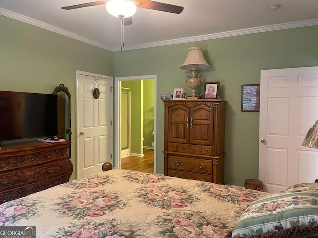 bedroom featuring crown molding, ceiling fan, and wood finished floors