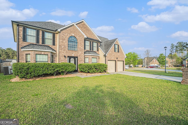 4180 W Stubbs Rd, College Park, GA 30349 - view of front of house with central air condition unit, concrete driveway, a front yard, and brick siding