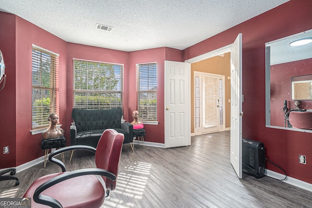 4180 W Stubbs Rd, College Park, GA 30349 - home office with a textured ceiling, baseboards, visible vents, and wood finished floors