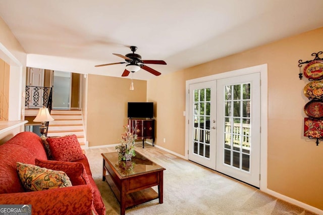 living room with french doors, ceiling fan, baseboards, and carpet floors
