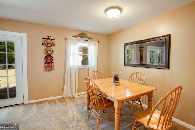 dining space with baseboards and carpet floors