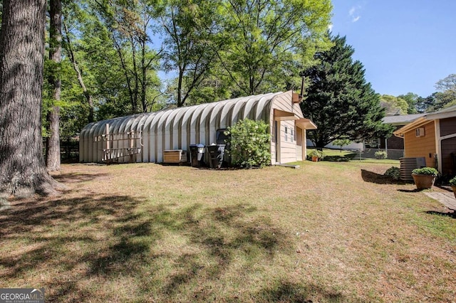 view of yard featuring cooling unit and an outbuilding