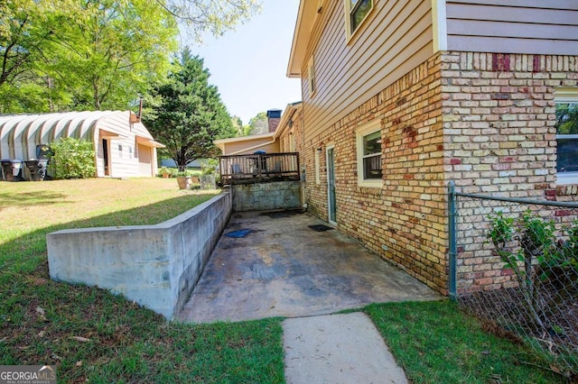 view of side of property with brick siding and a lawn