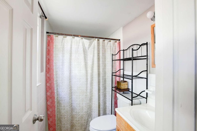 bathroom with toilet, a shower with shower curtain, and vanity