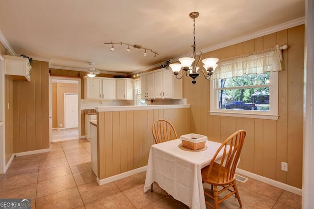 dining area featuring crown molding, light tile patterned floors, a chandelier, and visible vents