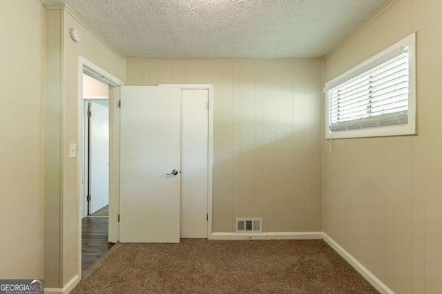 2304 Ousley Ct, Decatur, GA 30032 - spare room with ornamental molding, visible vents, carpet flooring, and a textured ceiling