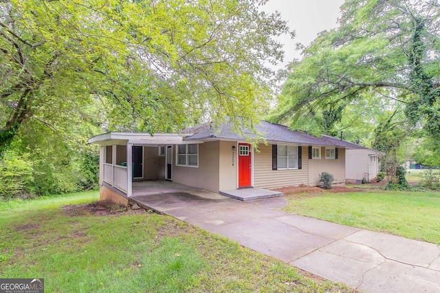 2304 Ousley Ct, Decatur, GA 30032 - ranch-style house with a carport, driveway, a front yard, and stucco siding