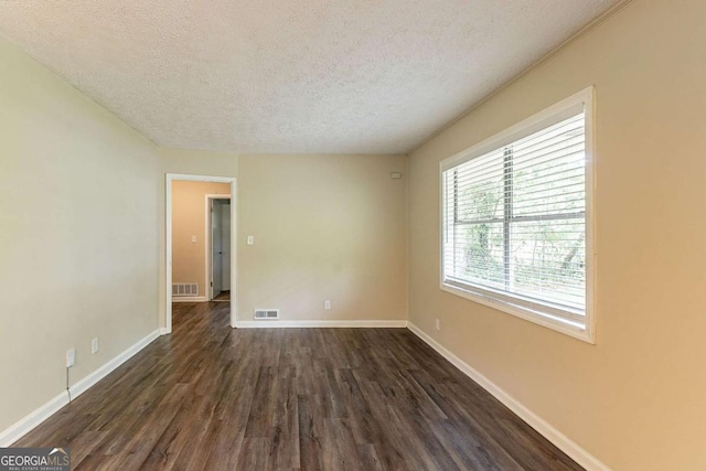 2304 Ousley Ct, Decatur, GA 30032 - spare room featuring visible vents, a textured ceiling, baseboards, and dark wood-style floors