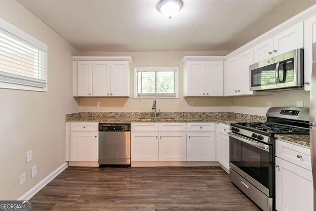 2304 Ousley Ct, Decatur, GA 30032 - kitchen featuring a sink, stone counters, white cabinets, and stainless steel appliances