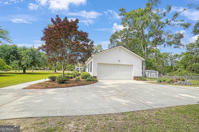 126 Patrick St, Swainsboro, GA 30401 - view of front of home with a front lawn, an attached garage, and concrete driveway