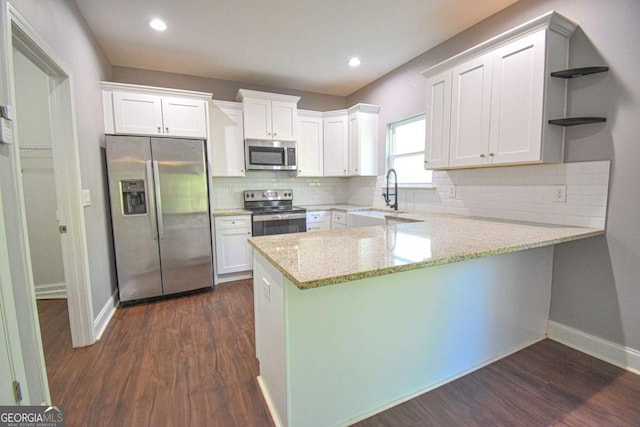 191 Fairview Oak Trl, Dallas, GA 30157 - kitchen with stainless steel appliances, open shelves, a peninsula, white cabinets, and dark wood-style floors