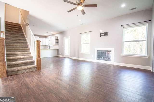 191 Fairview Oak Trl, Dallas, GA 30157 - unfurnished living room with a ceiling fan, dark wood finished floors, stairs, healthy amount of natural light, and recessed lighting