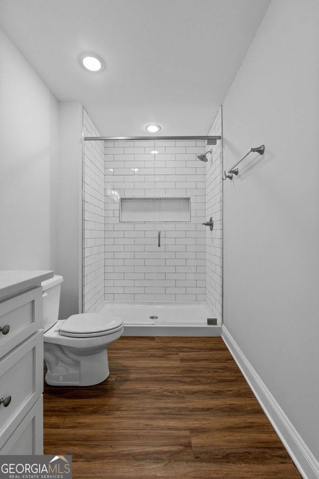 485 Swint Rd, Griffin, GA 30224 - full bathroom with toilet, a stall shower, vanity, wood finished floors, and recessed lighting