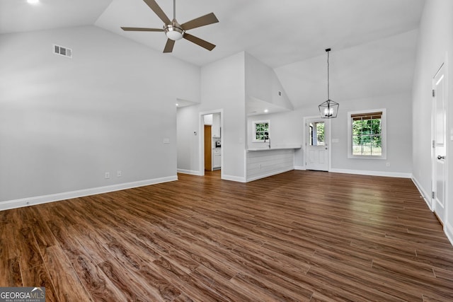 485 Swint Rd, Griffin, GA 30224 - unfurnished living room featuring a ceiling fan, high vaulted ceiling, dark wood-style floors, a chandelier, and baseboards