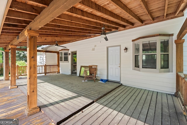 wooden deck featuring ceiling fan