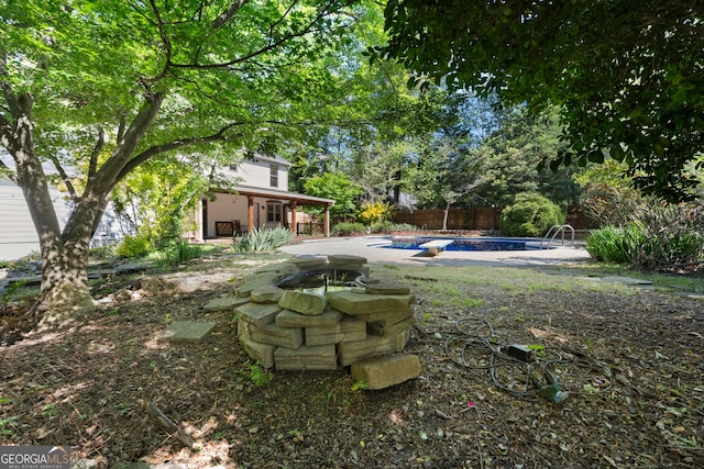 view of yard featuring a patio area, an outdoor pool, and a fenced backyard