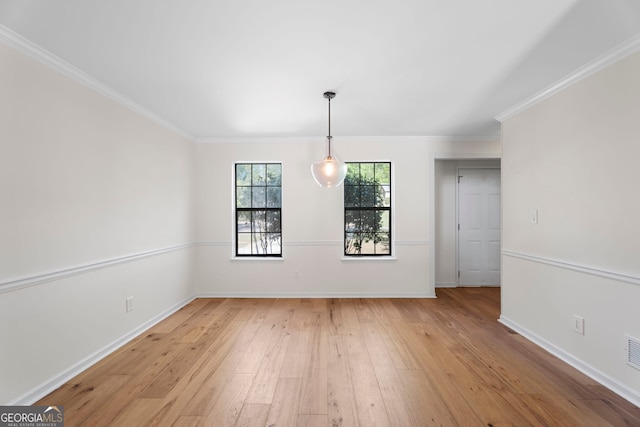 unfurnished dining area with ornamental molding, baseboards, and light wood-style floors