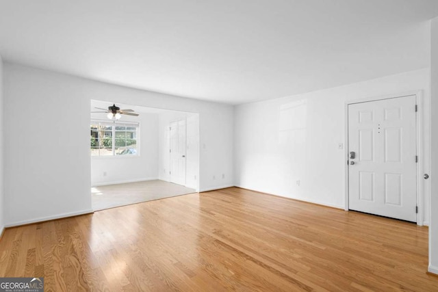 1468 Briarwood Rd NE Unit 602, Atlanta, GA 30319 - unfurnished living room featuring light wood-style floors, ceiling fan, and baseboards